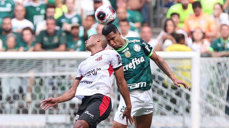 Rafael Navarro of Palmeiras competes for the ball with Claudinho